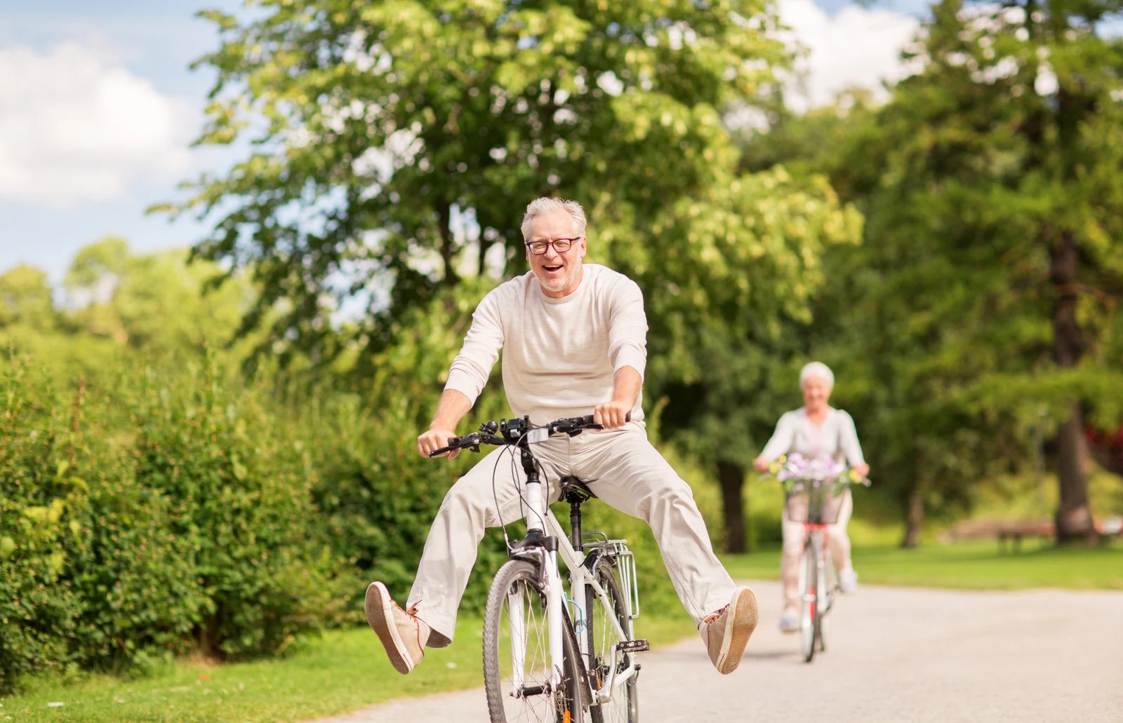 Happy couple riding a bike, a Catholic Social Services impact story