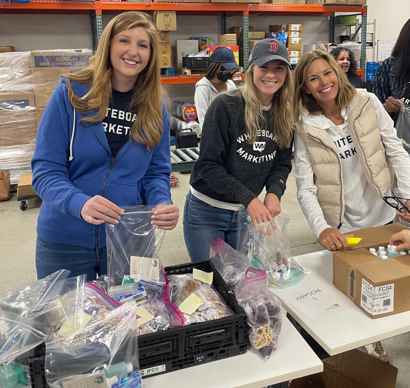 Catholic Social Services volunteer stocking shelves at a food pantry