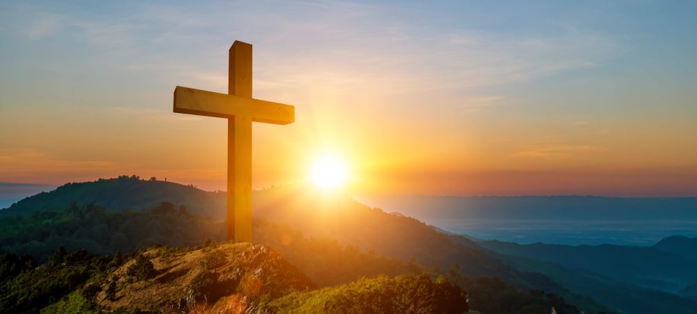 Crucifixion of Jesus Christ on the cross at sunset
